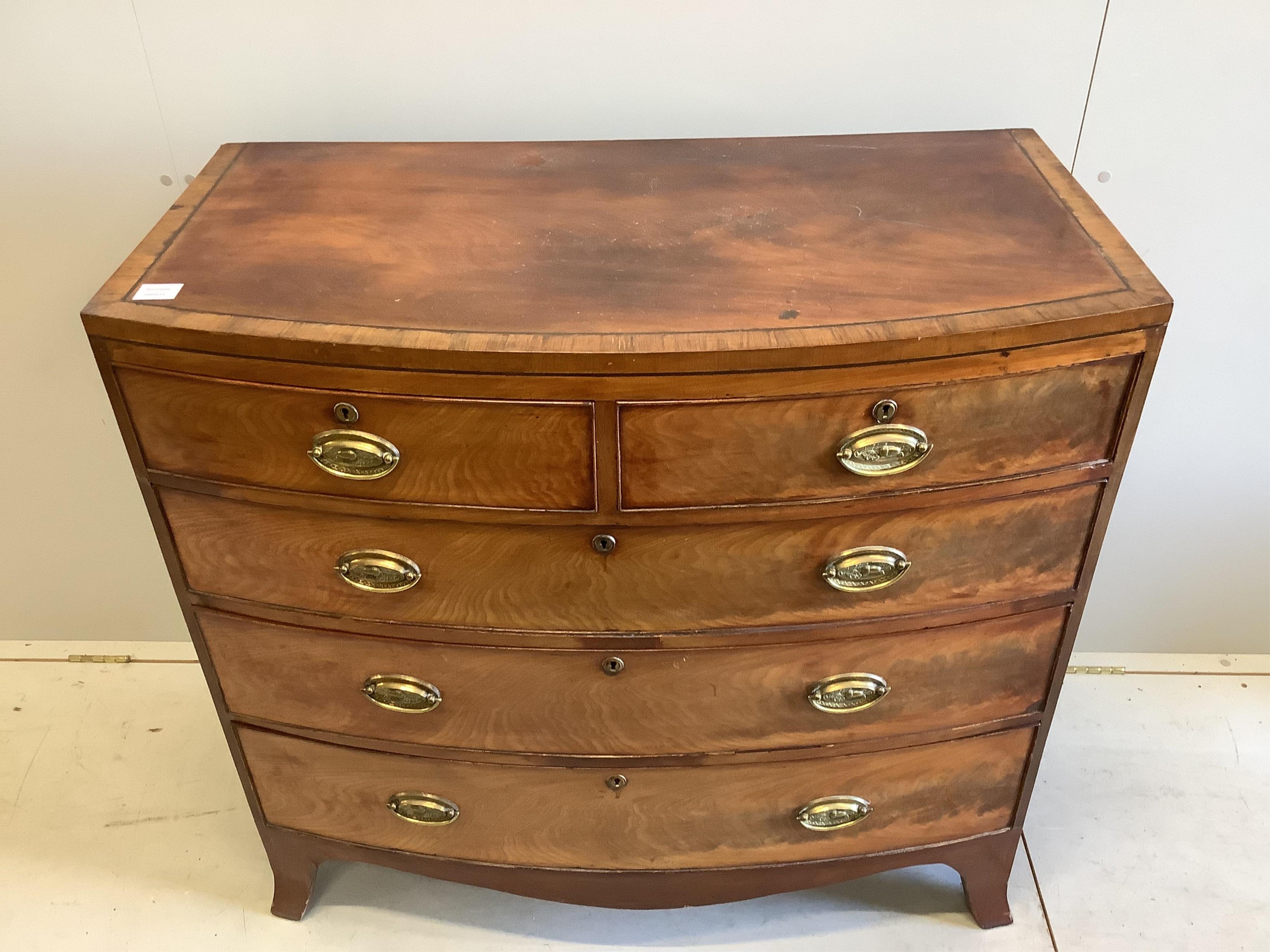 A Regency banded mahogany bowfronted chest, fitted two short and three long drawers, with oval stamped brass handles, width 103cm, depth 54cm, height 97cm. Condition - poor to fair